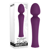 The Evolved My Secret Wand Vibrator, a purple silicone, wand-shaped personal massager with a flexible head, is displayed beside its white and purple packaging labeled "Evolved" and "My Secret Wand." The packaging emphasizes that the powerful waterproof wand vibrator is rechargeable and includes a travel bag.